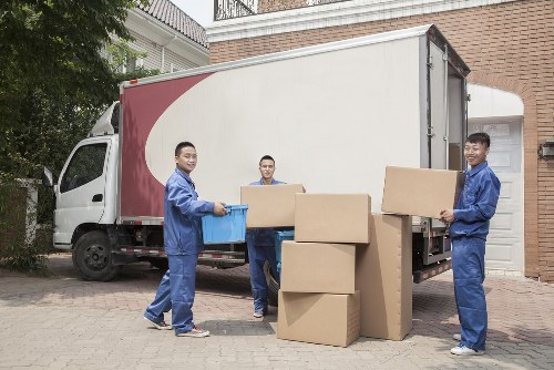 Local movers handling a residential move in Bow with boxes and furniture