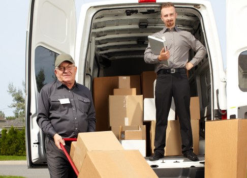 Man with a van loading furniture for a Bow home move