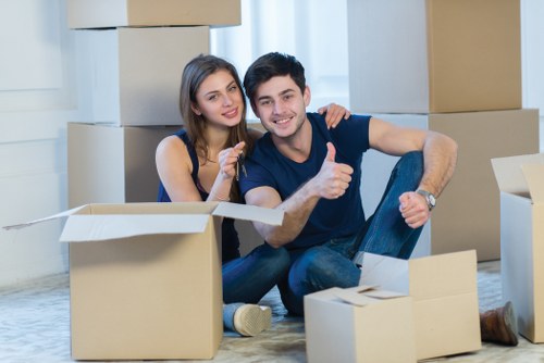 Movers handling furniture in a Bow flat