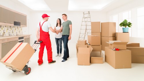 Commercial movers handling office items in an East London street