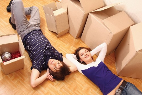 Professional team handling desks and office furniture during a Bow move