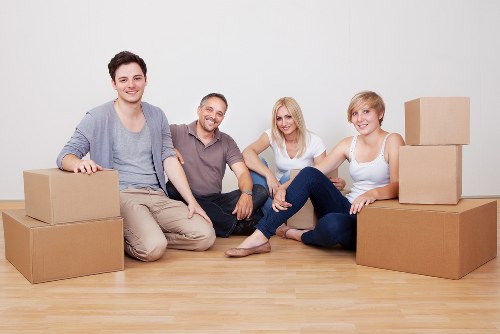 Packed household boxes and furniture ready for transport in Bow